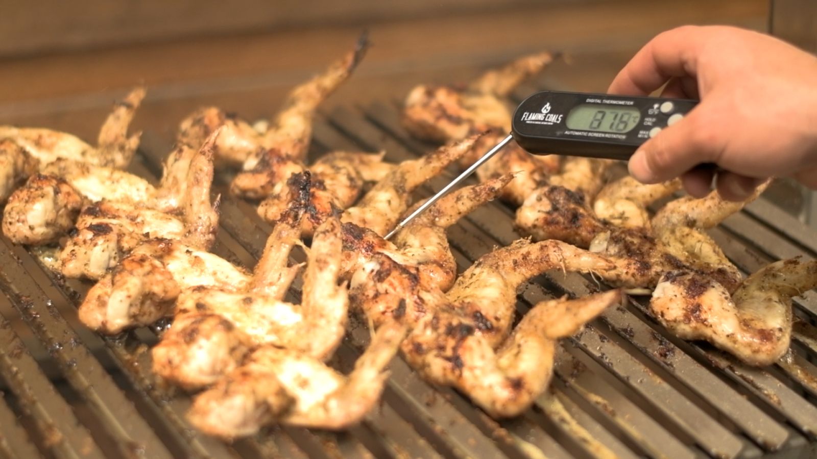 Checking temperature of chicken wings