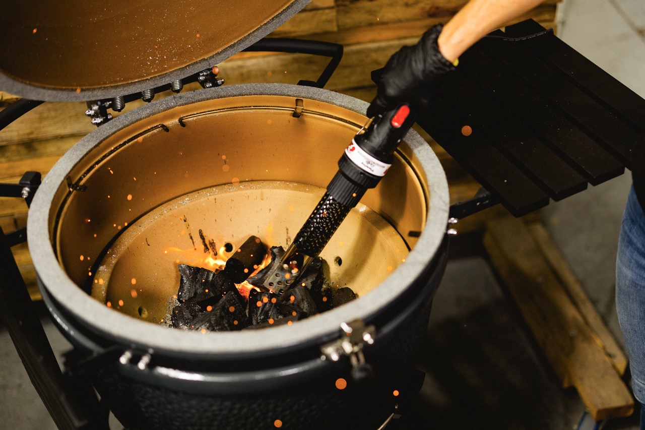 This image shows the Charcoal Starter Wand lighting up charcoals.