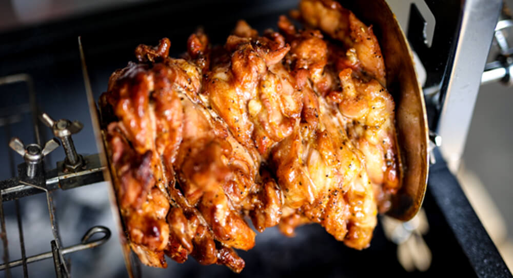 Juicy chicken gyros roasting on a rotisserie using a gyros disc, with golden caramelised edges and a perfectly even cook. Juicy chicken gyros roasting on a rotisserie using a gyros disc, with golden caramelised edges and a perfectly even cook.