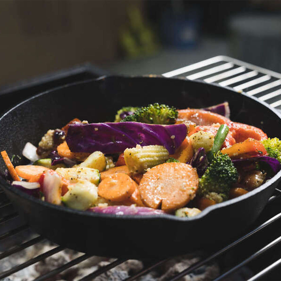 This image shows a cast iron pan cooking some veggies