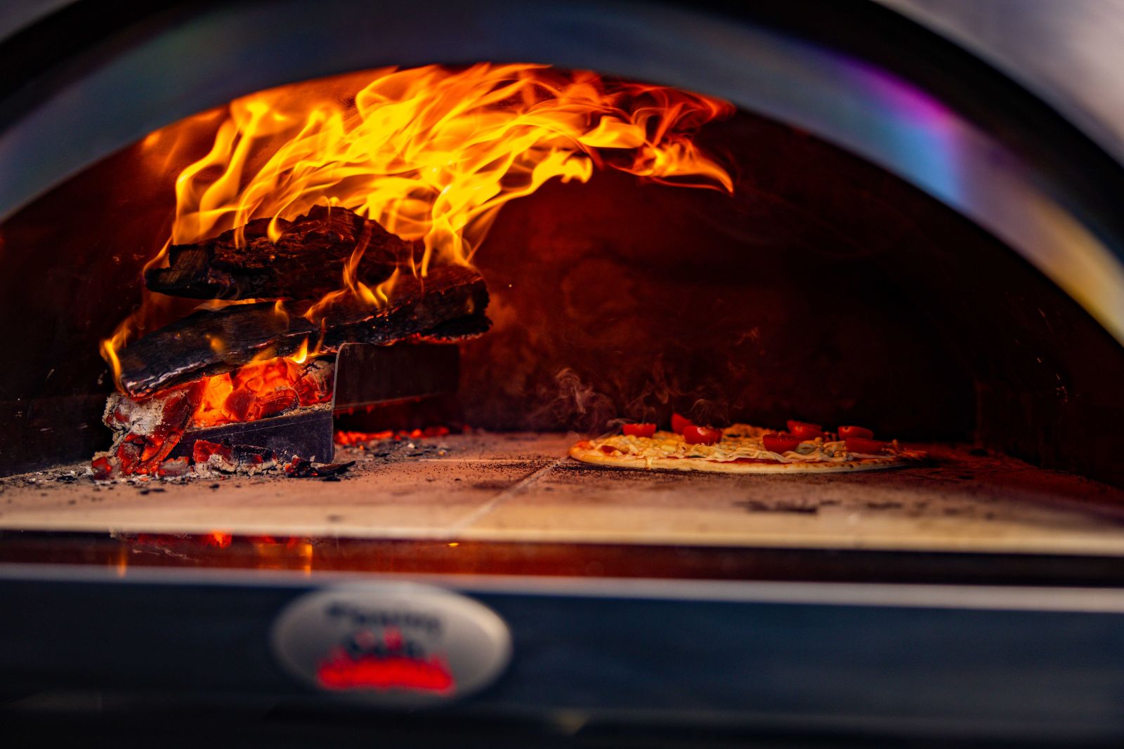 This image shows the Raised Log Holder used in a pizza oven.