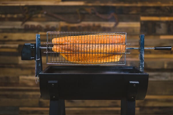 Salmon being cooked jumbuck mini Spit using the rotisserie basket large