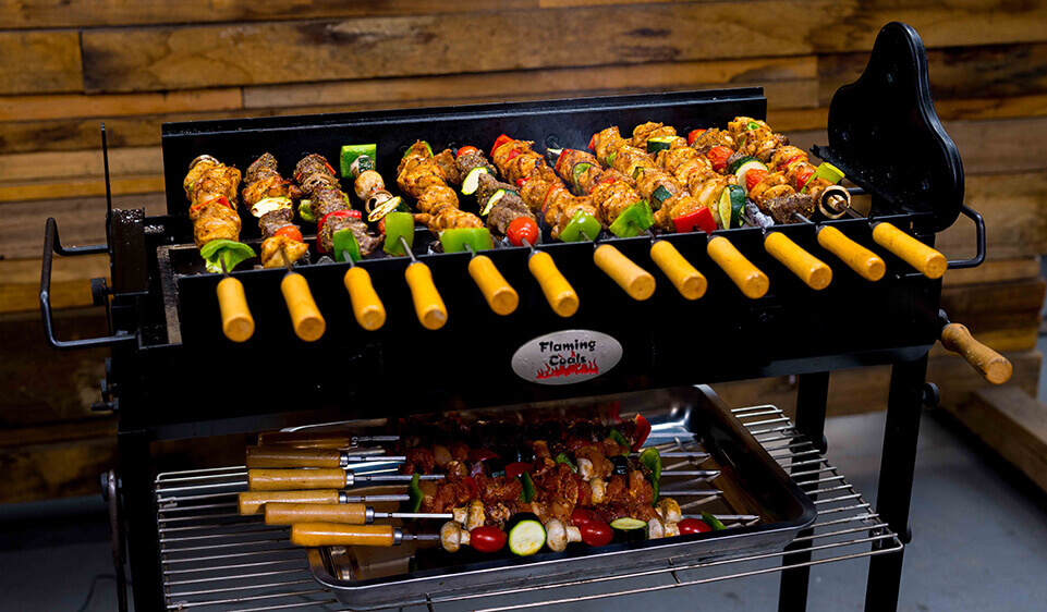 This_image_shows_Flaming_Coals_Cyprus_Spit_being_used_to_cooked_Kebab