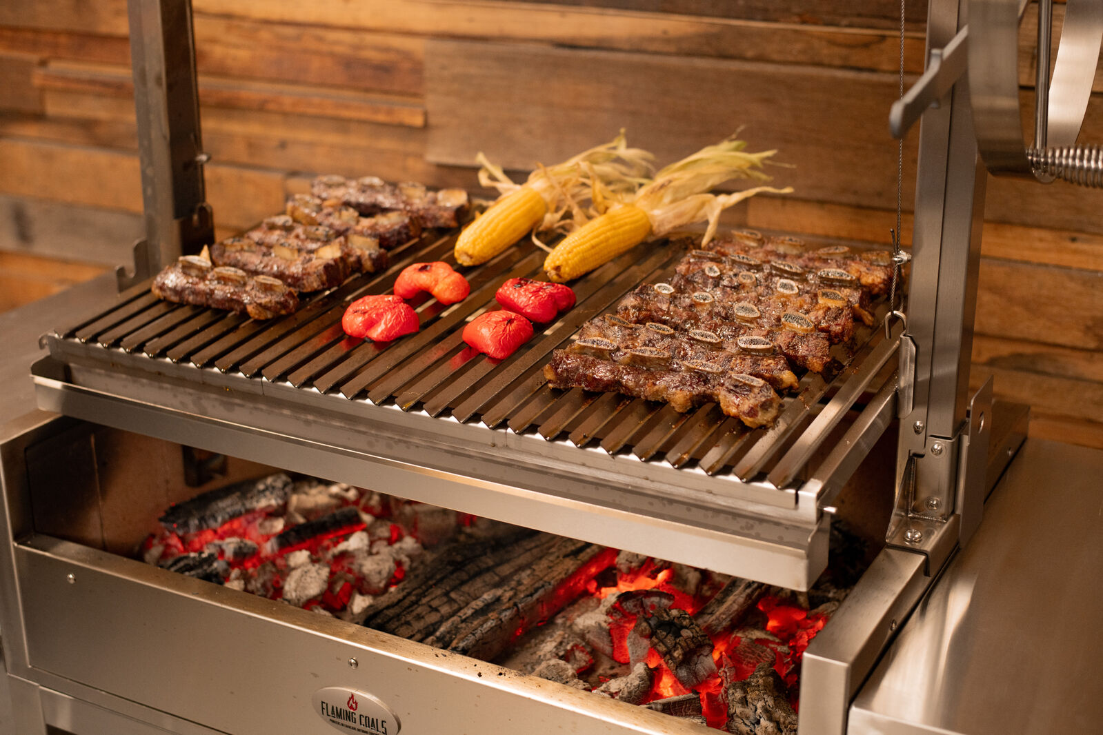 This_image_shows_various_meat_and_veggies_being_cooked_on_Flaming_Coals_Parrilla_BBQ 