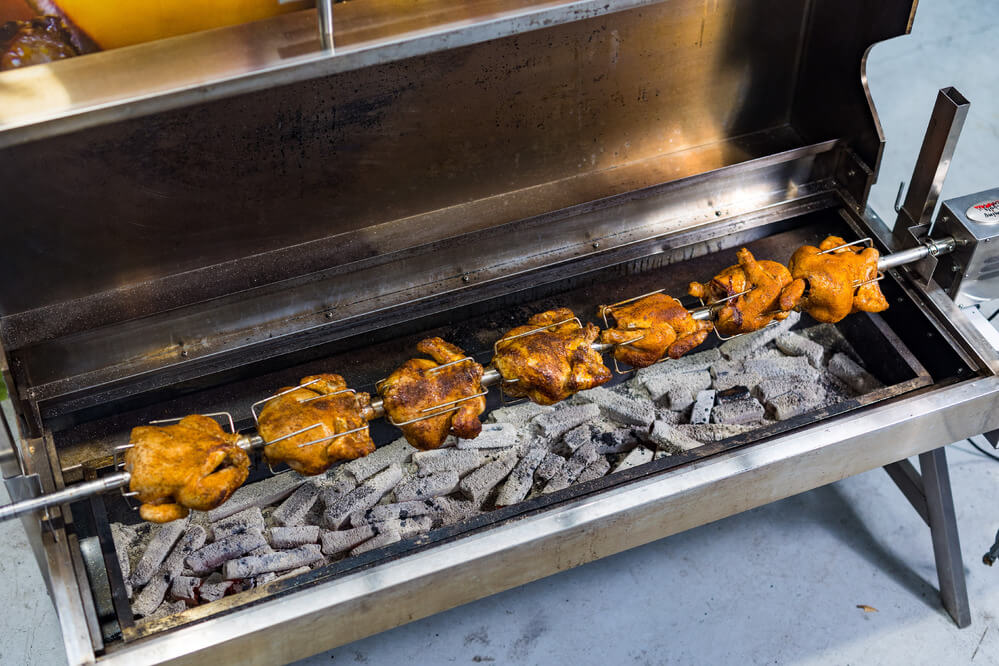 This is an image of the Spartan Spit cooking whole chickens.