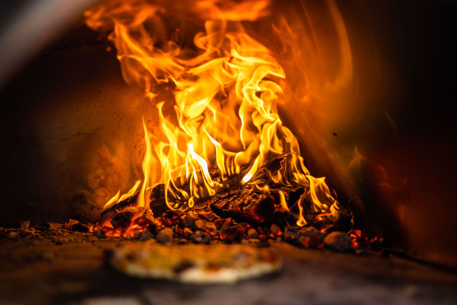 This image shows wood burning in a pizza oven