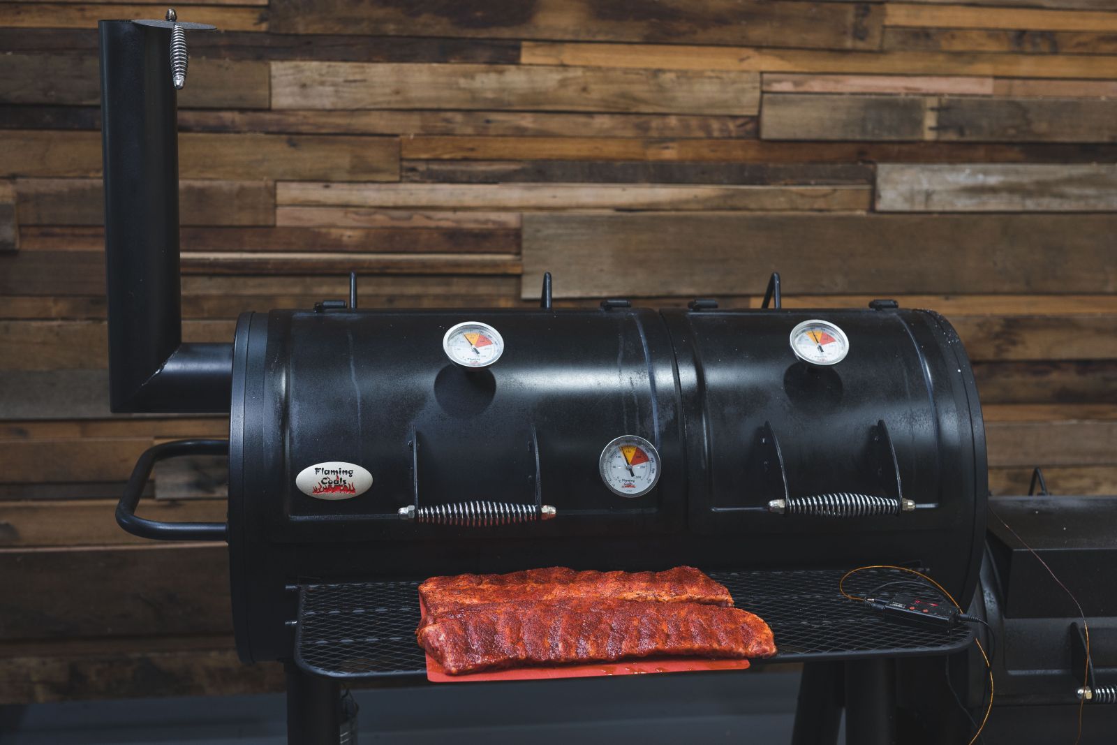 This image shows the Flaming Coals Offset Smoker and Pork Ribs This image shows the Flaming Coals Offset Smoker and Pork Ribs