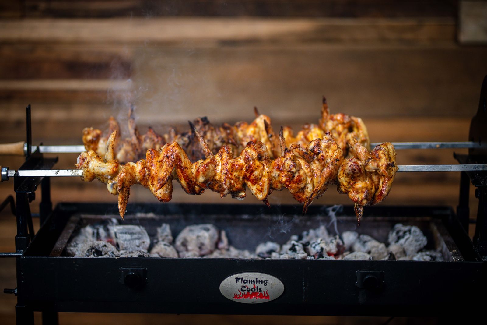 This is an image of the Cyprus spit cooking chicken wings.